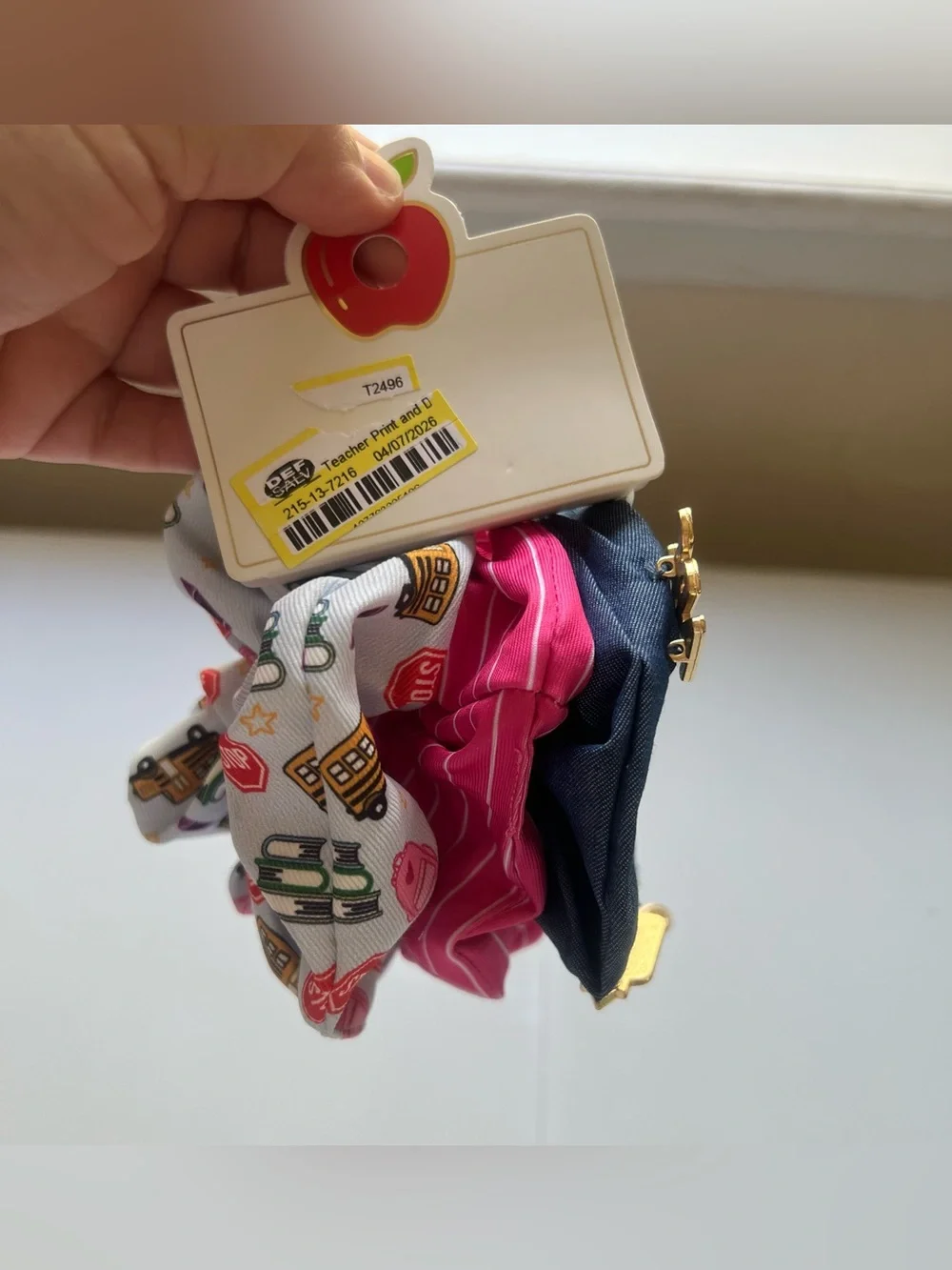 This is a 3-pack of themed hair scrunchies designed with school-related motifs.